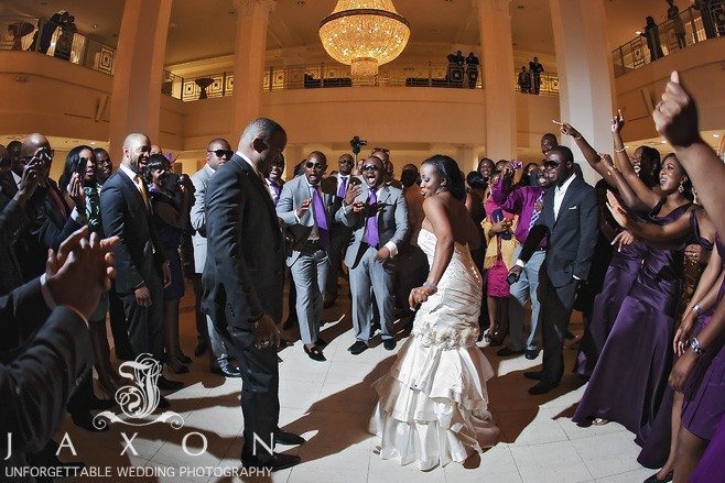 wedding party joins bride and groom on the dance floor in the Grand Atrium at 200 Peachtree as the party begins