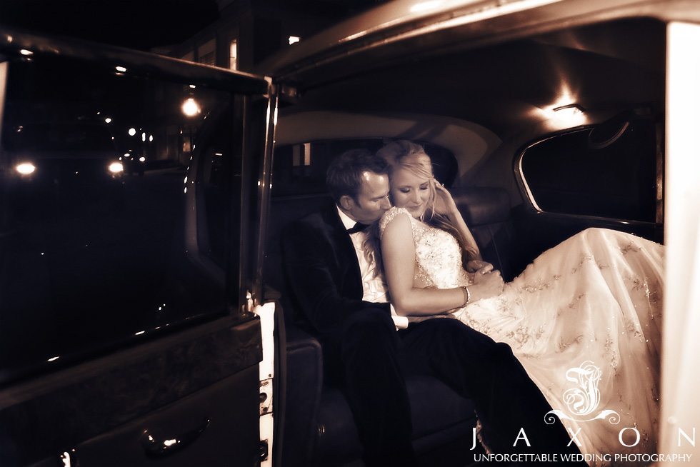 Couple in the backseat of a vintage Rolls at the end off the night | Peachtree Club Rooftop Wedding