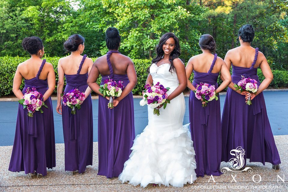 Bridesmaids showing off the back of their Mori Lee Style 712 plum colored convertible dresses at the Doubletree Roswell Wedding