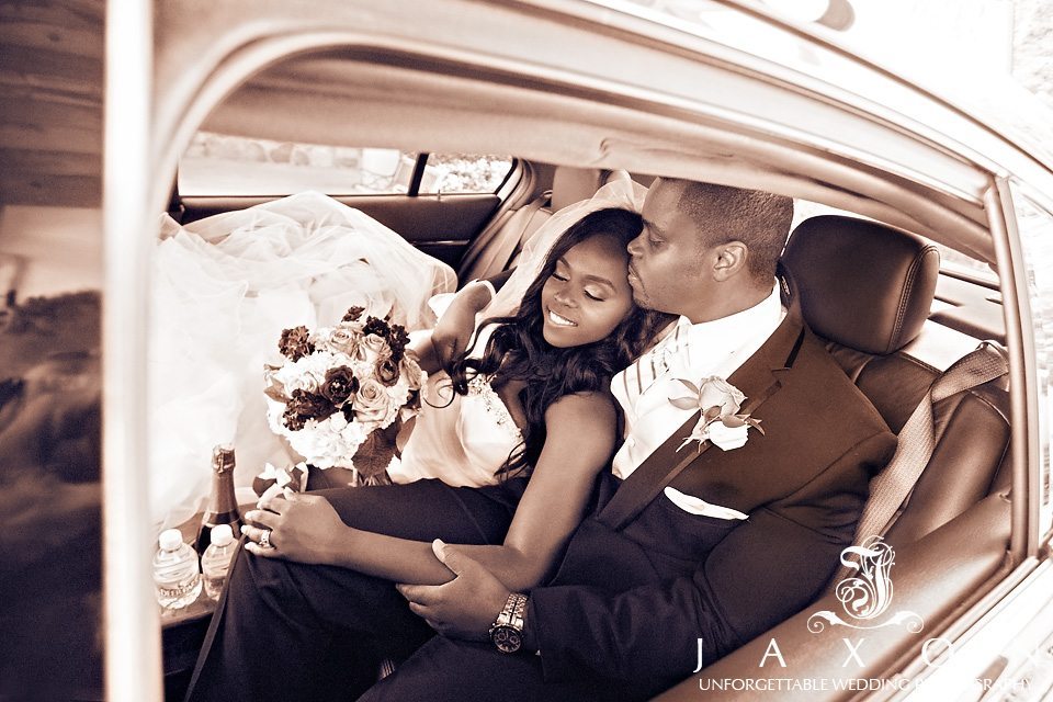 Sepia portrait of couple in the back of their limo at the end of a long day