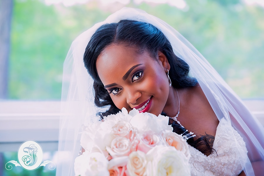 Portrait of bride with bouquet comprising of Peonies, Mother of Pearl and Sahara Roses at her Vines Mansion Wedding